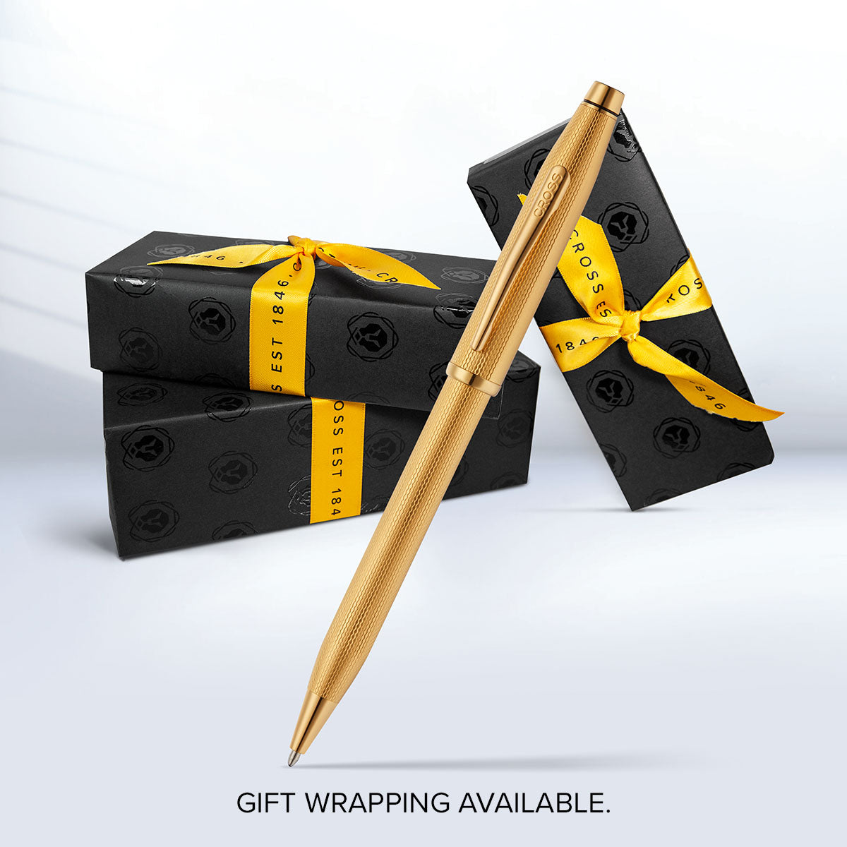 Gold-plated ballpoint pen with wrapped gift boxes and ribbon