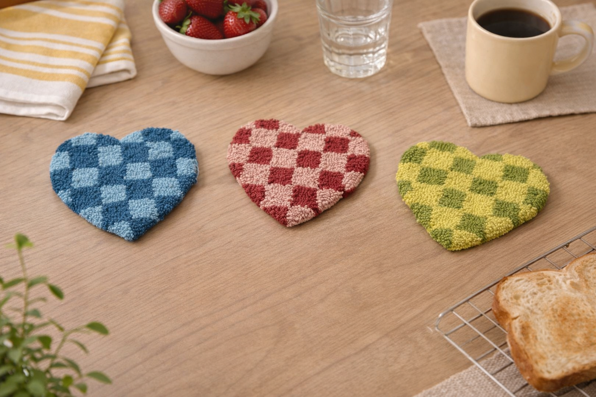 Heart-shaped tufted cotton trivets, blue red and green checkered.