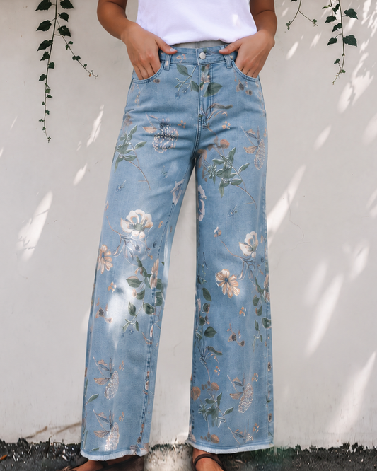 Floral print light blue denim shift jeans with wide legs, button front, and frayed hem