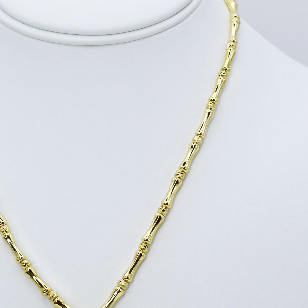 Gold-tone beaded necklace chain with bamboo-style links