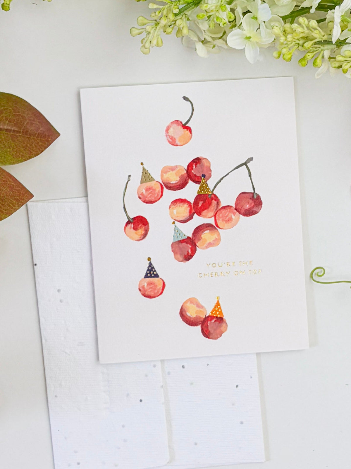 Seeded birthday card with watercolor cherries and gold message text