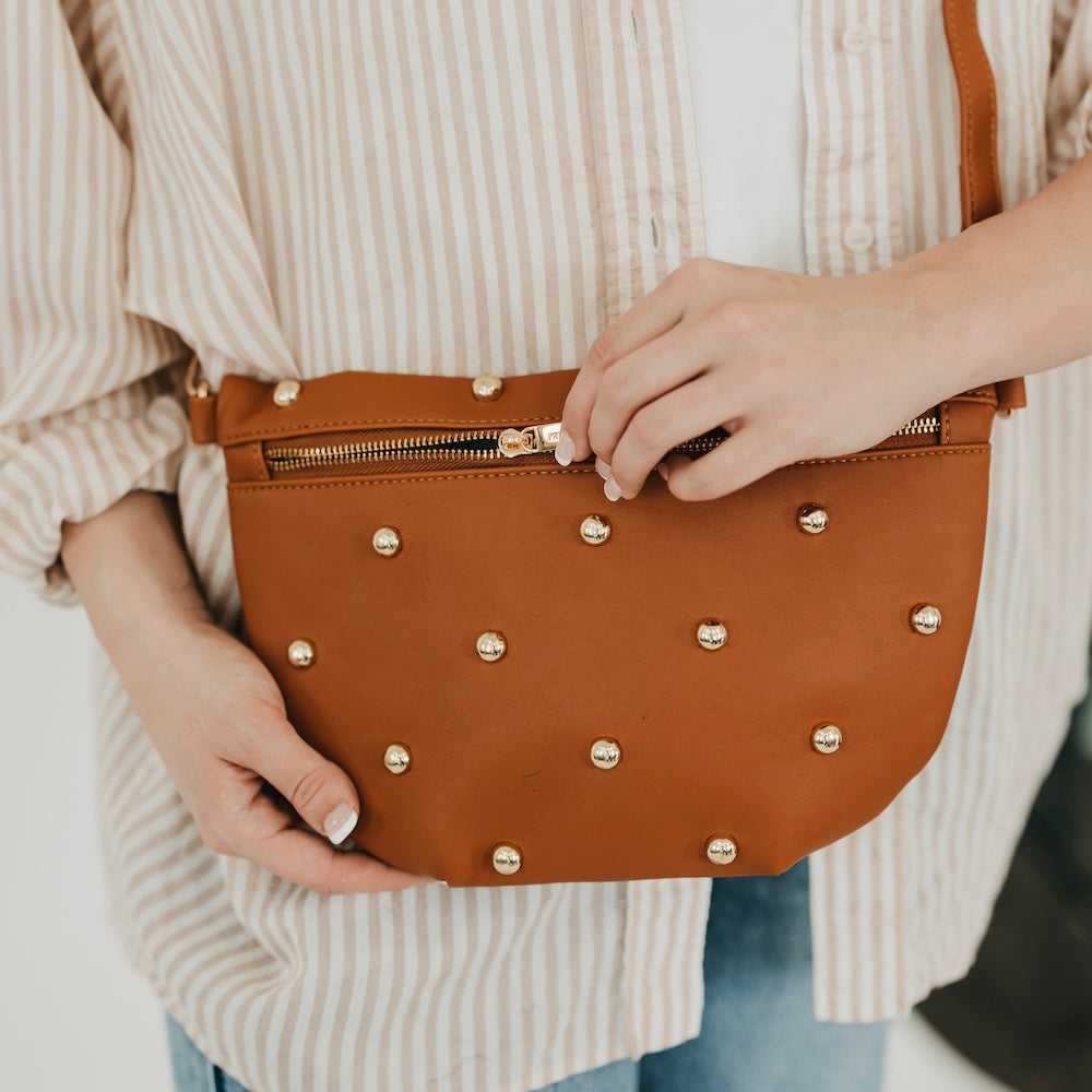 Brown faux-leather bum bag with gold studded front and top zipper