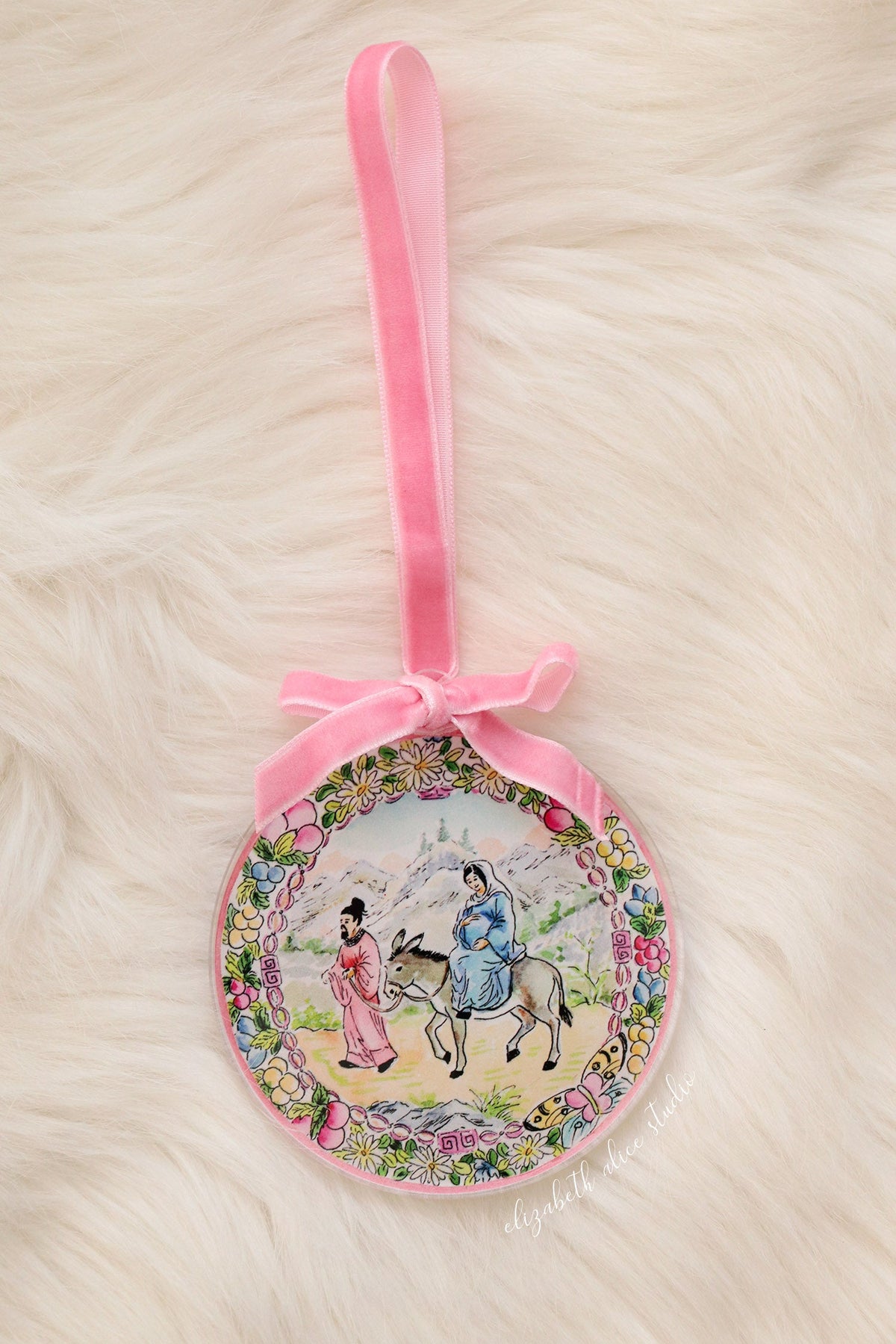 Round Bethlehem journey ornament with pink ribbon hanger and floral border