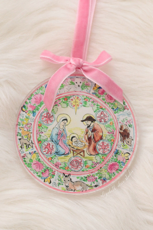 Round acrylic Nativity ornament with pink velvet bow and floral, multicolor scene