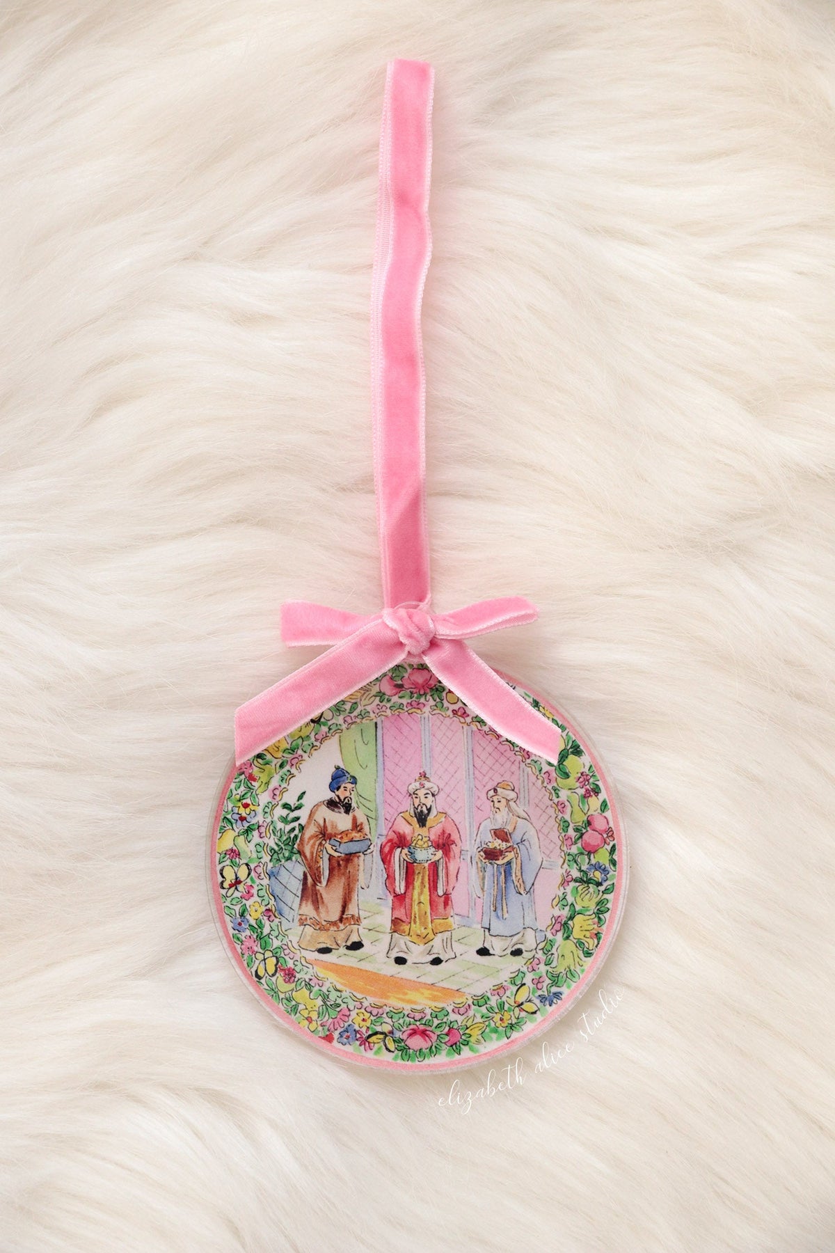 Round Magi ornament with floral border and long pink velvet ribbon