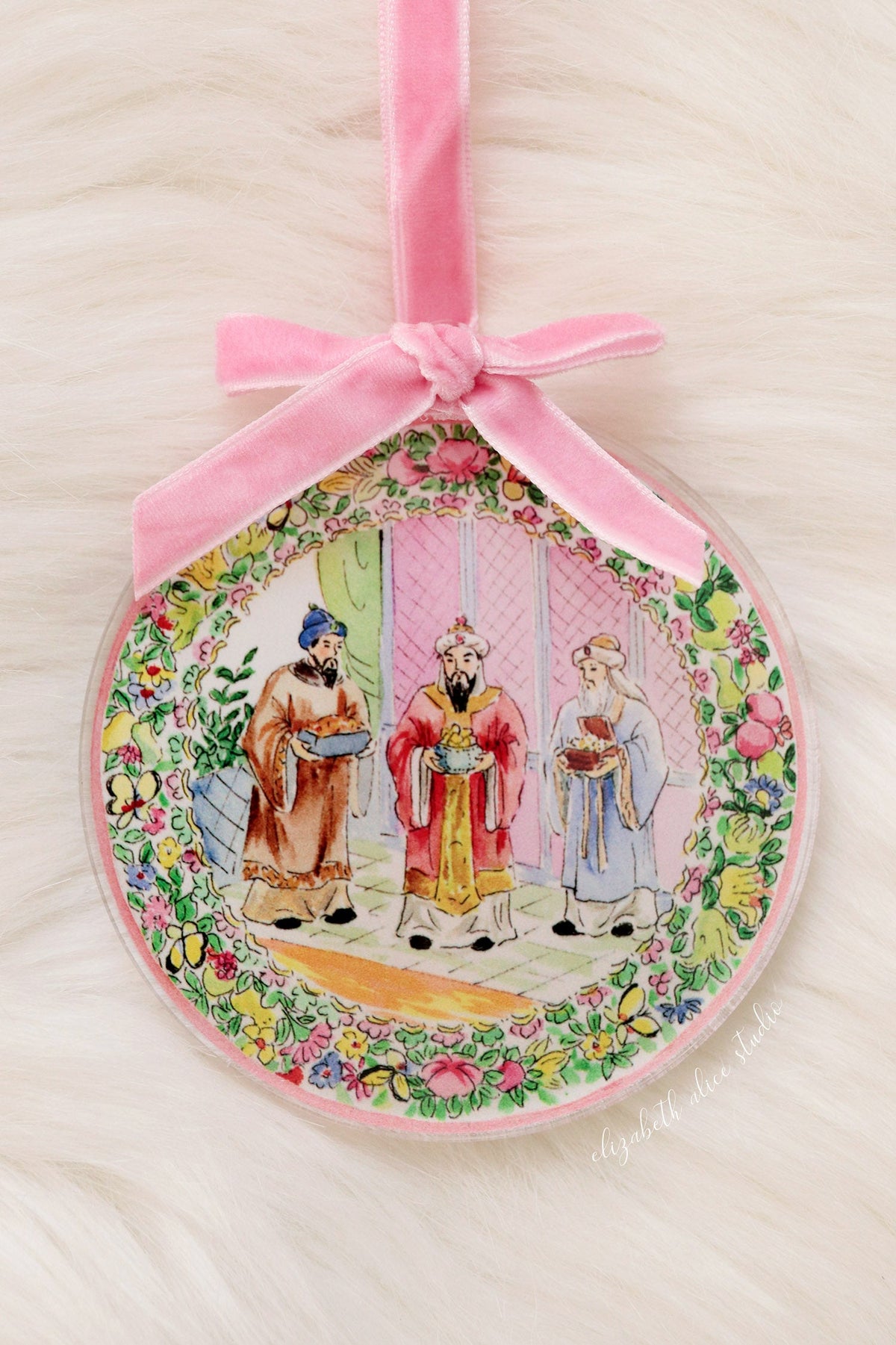 Round acrylic Magi ornament with floral border and pink velvet bow hanger