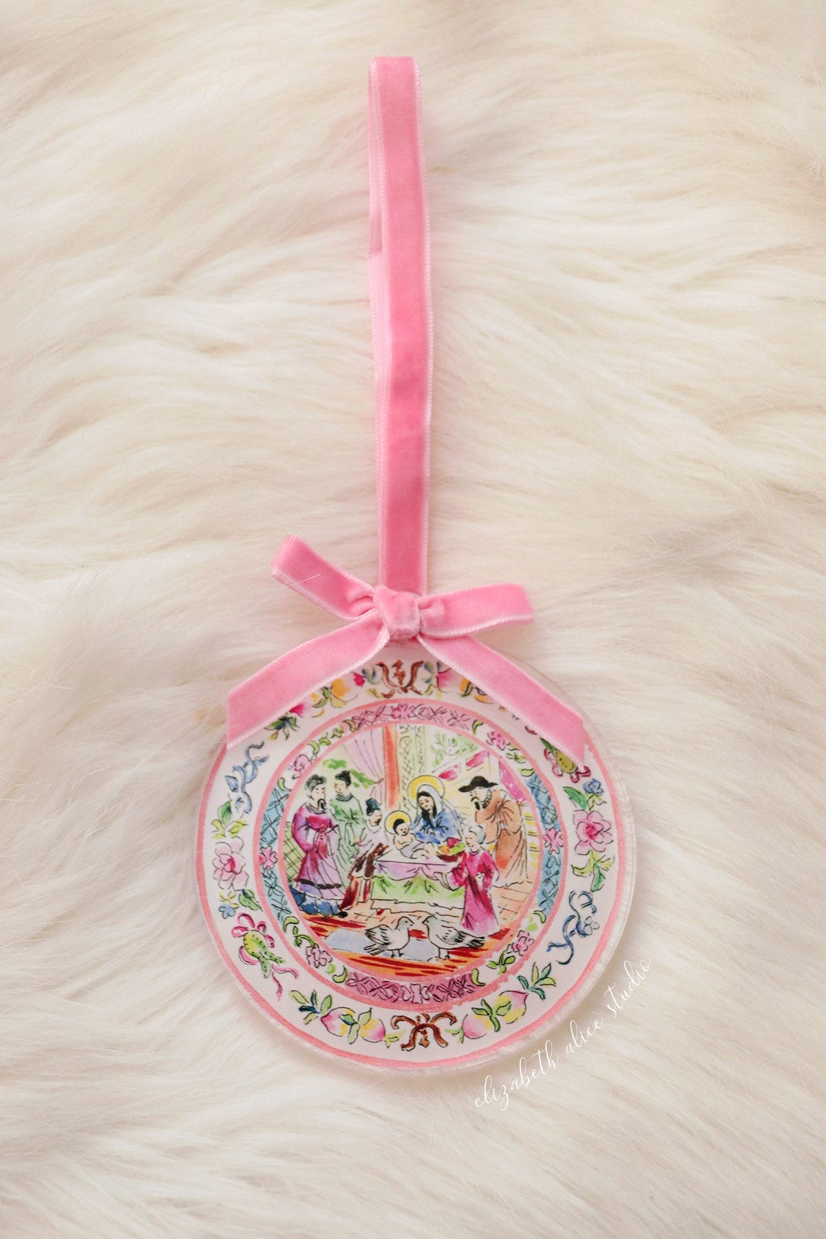 Round acrylic ornament with pink ribbon hanger and temple scene illustration