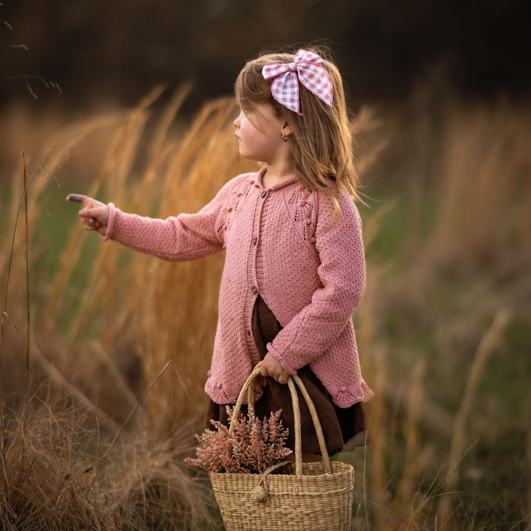 Dusty rose knit cardigan with button front, long sleeves, and scalloped hem