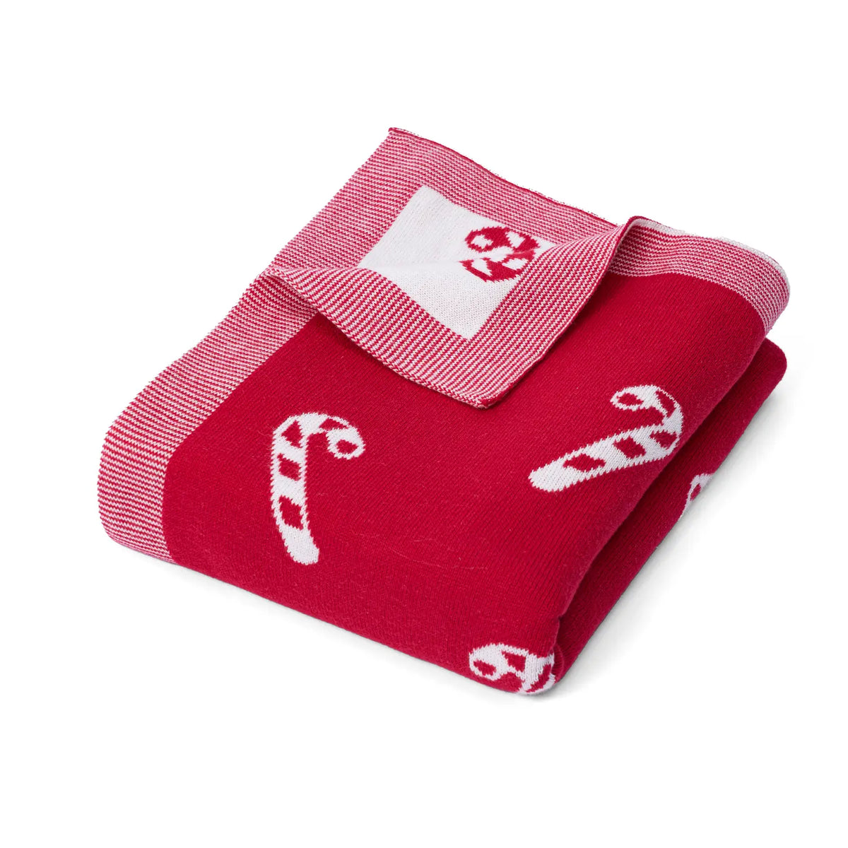 Folded red knit baby blanket with white candy cane pattern and striped border