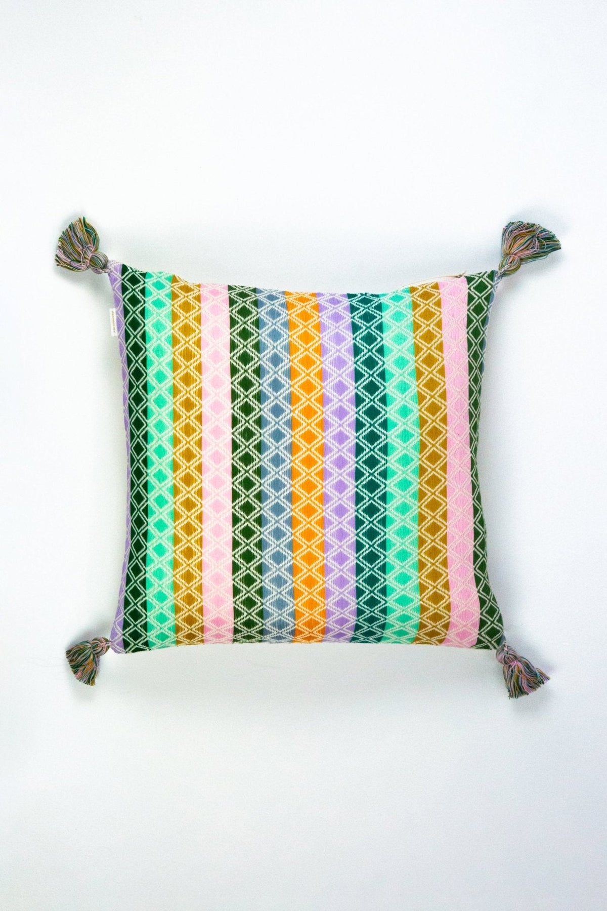 Rectangular multi-pattern throw pillow with vertical striped design and tassel corner ties