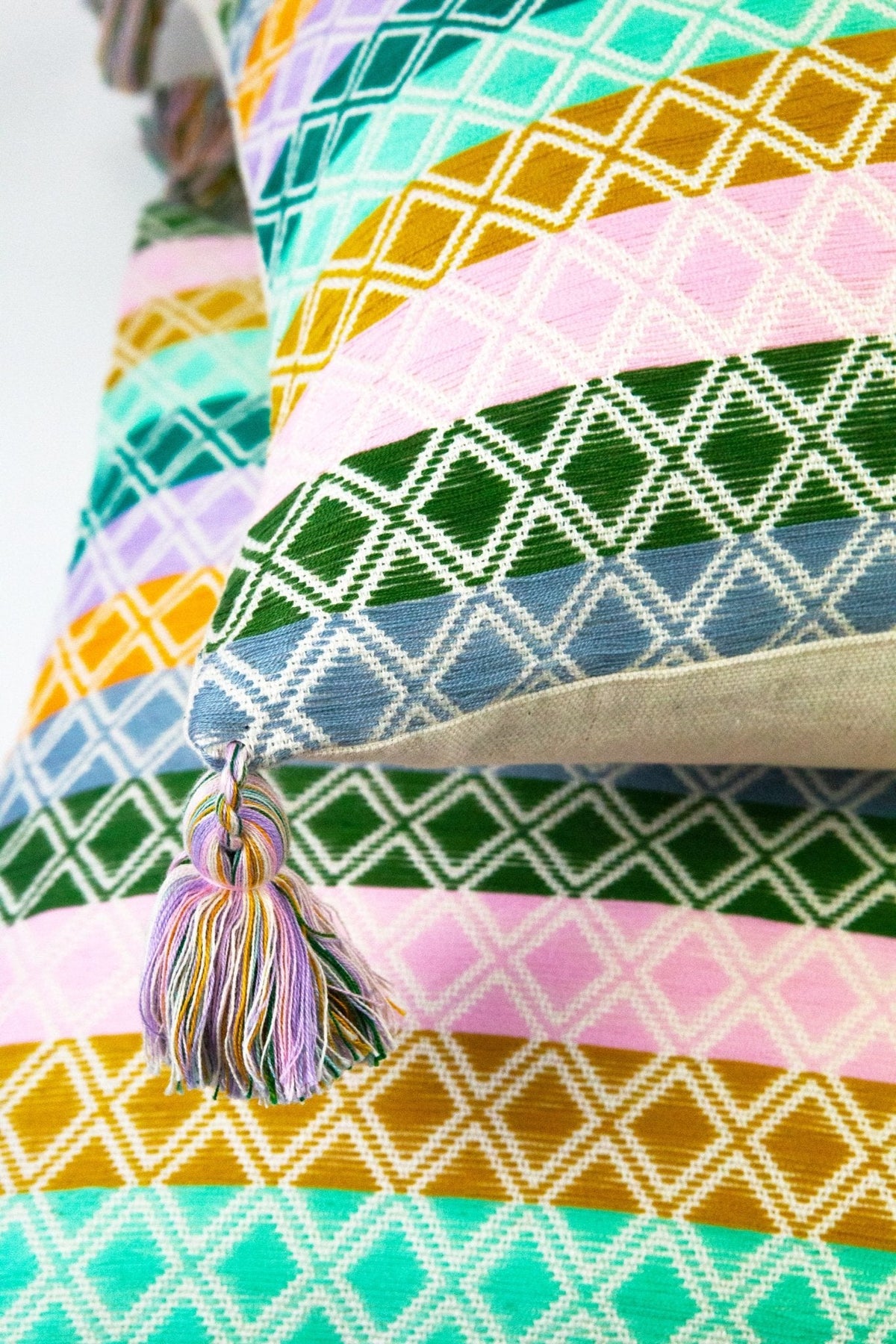 Comalapa multi-pattern pillow with geometric lattice print and multicolor tassel detail