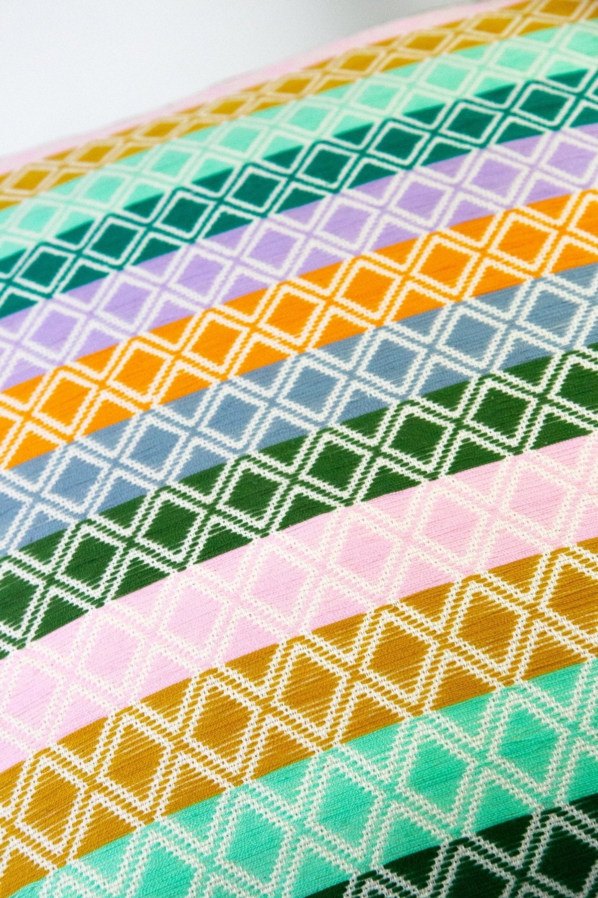Close-up of multicolor geometric lattice fabric for pillow cover