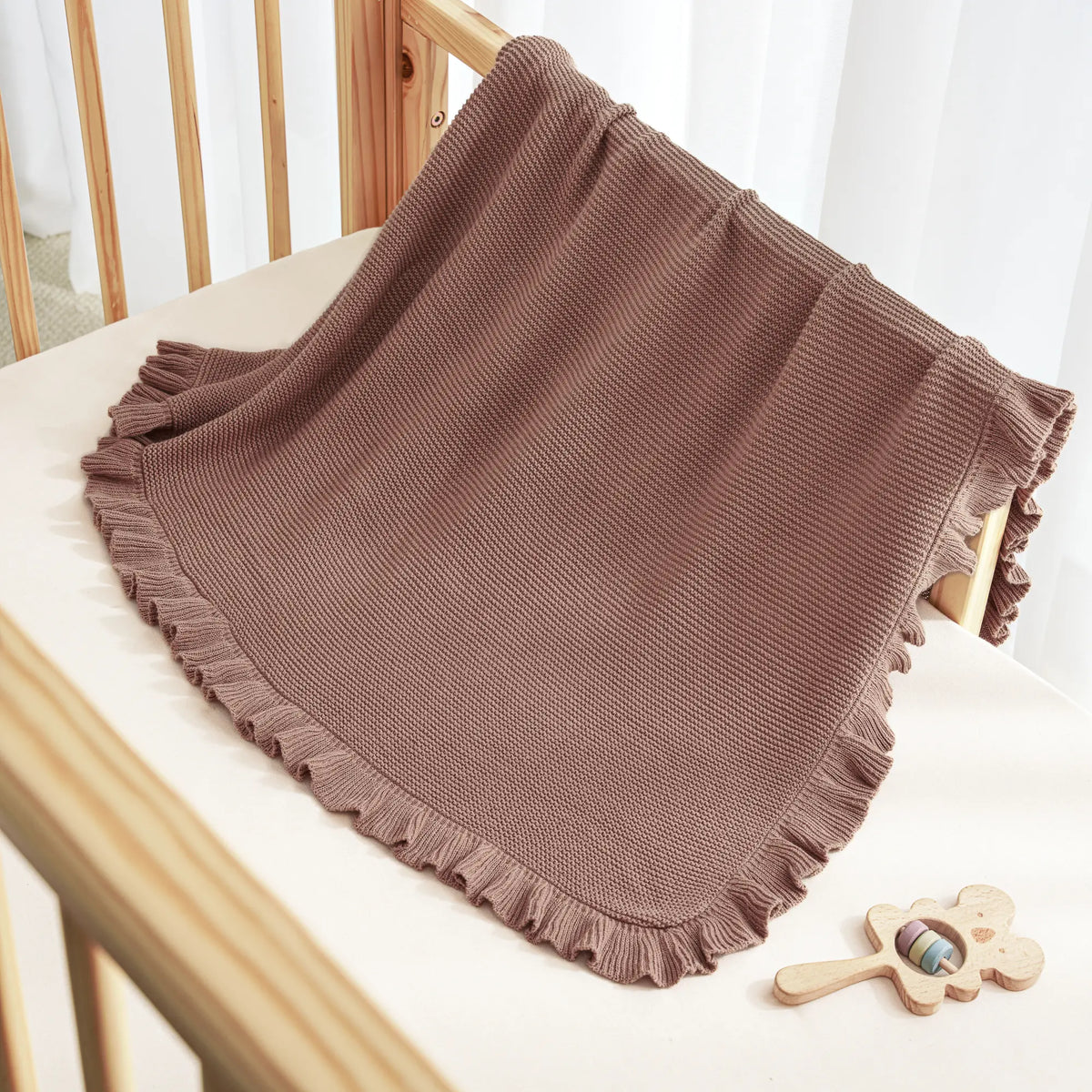 Mocha knit baby blanket with layered ruffled border edge and textured knit surface
