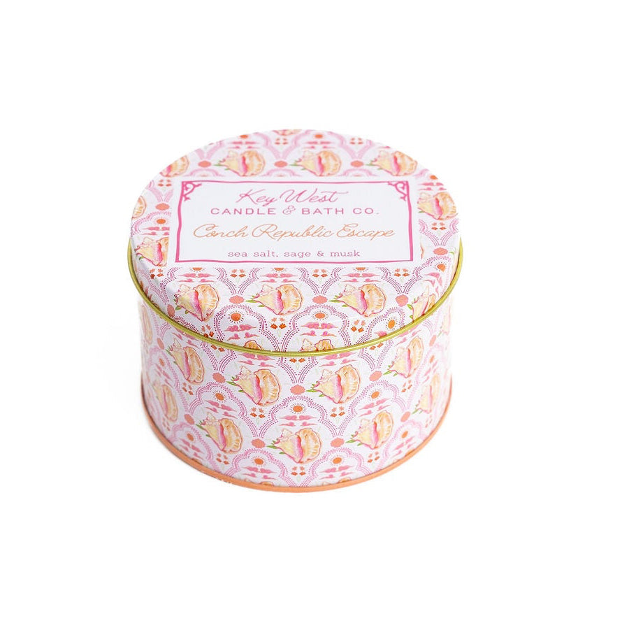 Pink patterned travel tin candle with gold rim; “Key West Candle & Bath Co” label