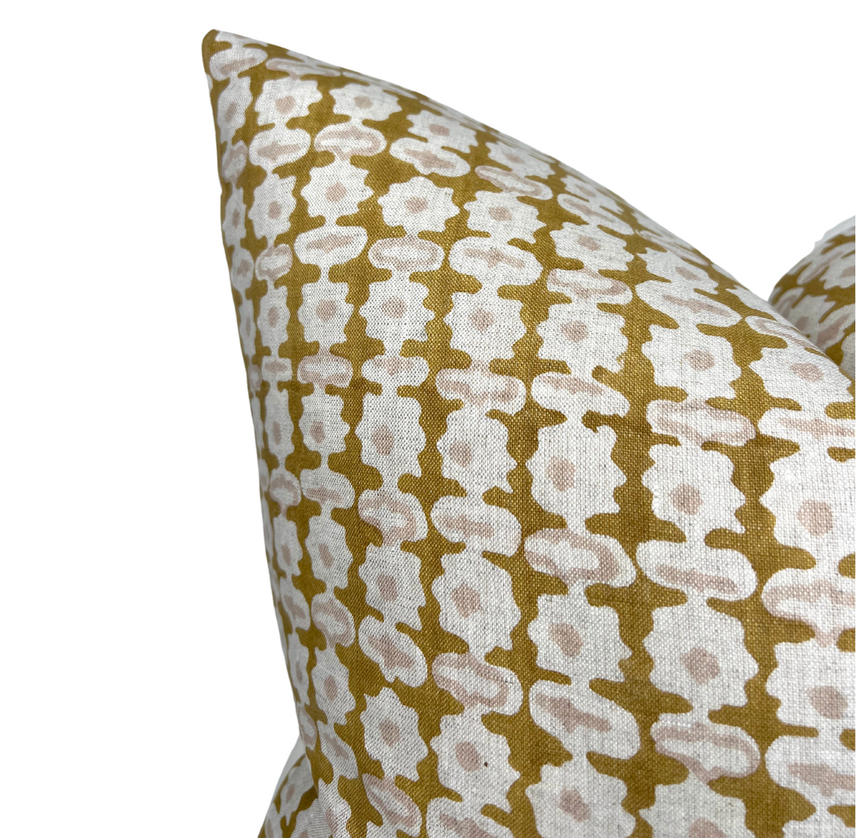 Corner close-up of geometric print pillow cover in cream and dark olive