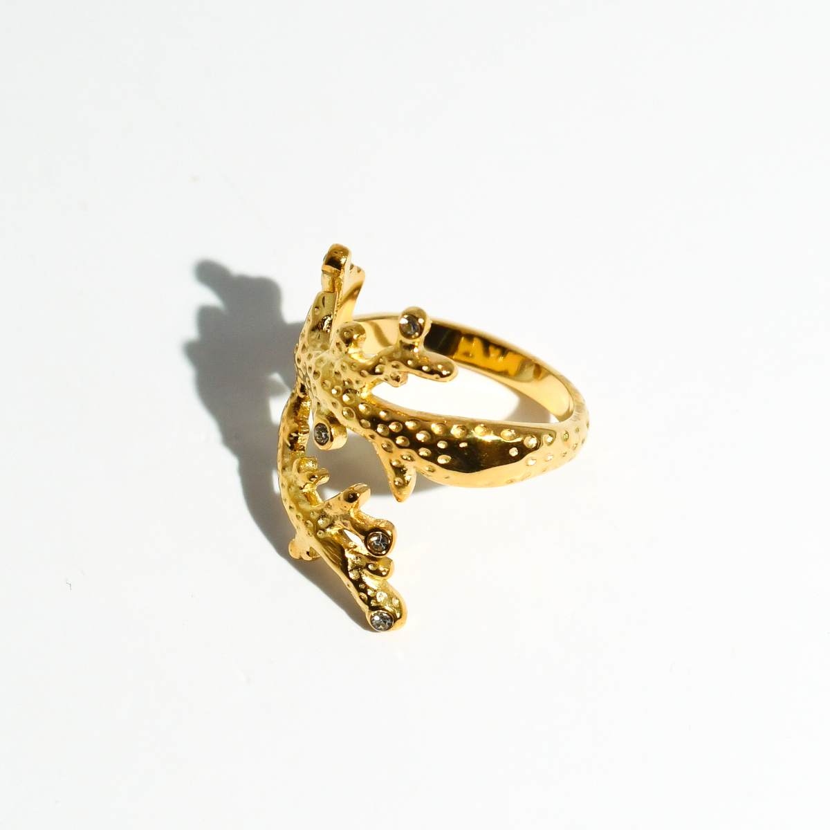 Gold coral crown ring, side view with scalloped band and crystal accents