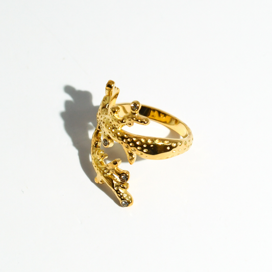 Gold coral crown ring, side view with scalloped band and crystal accents