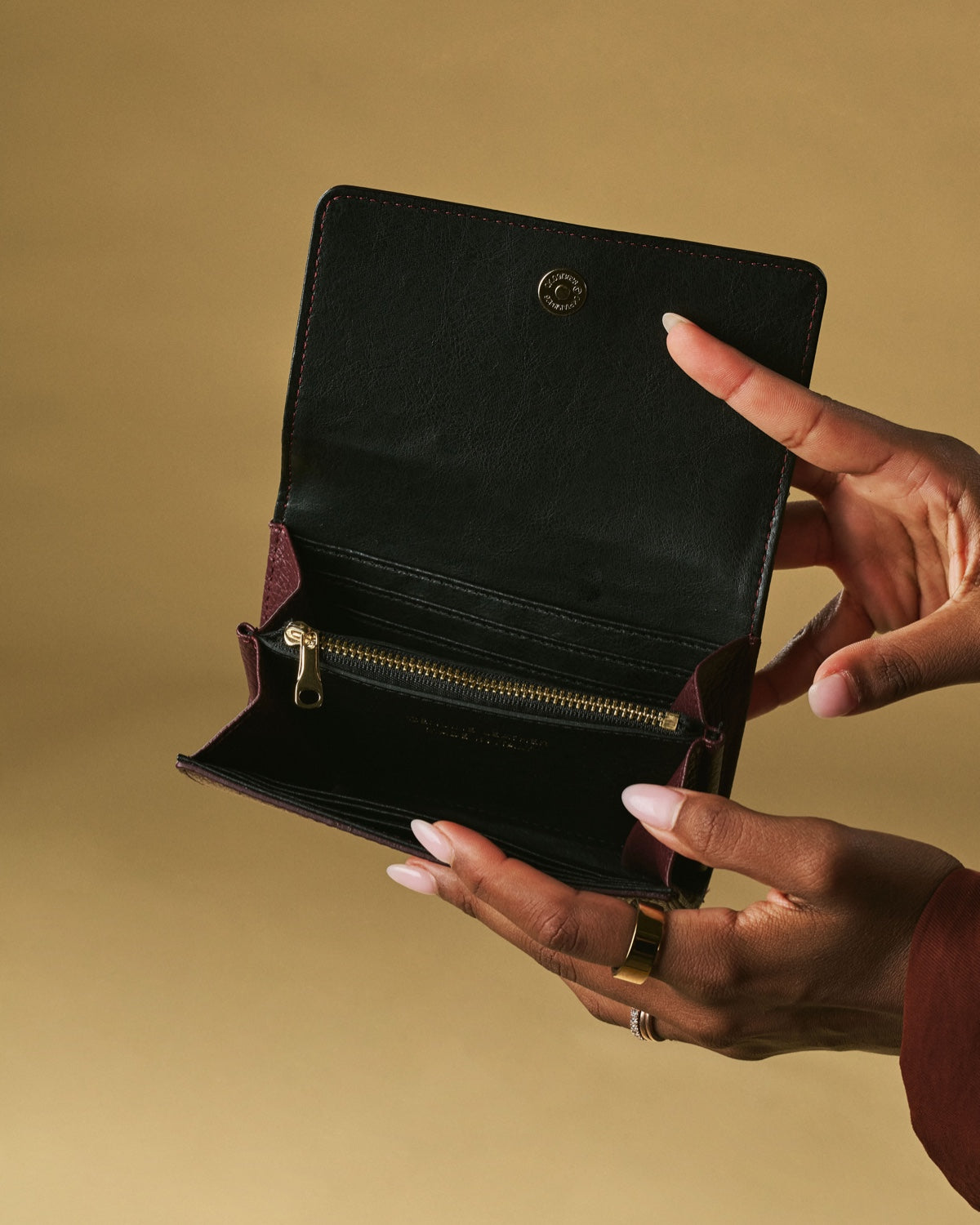 Open black leather wallet with zip coin pocket and card slots