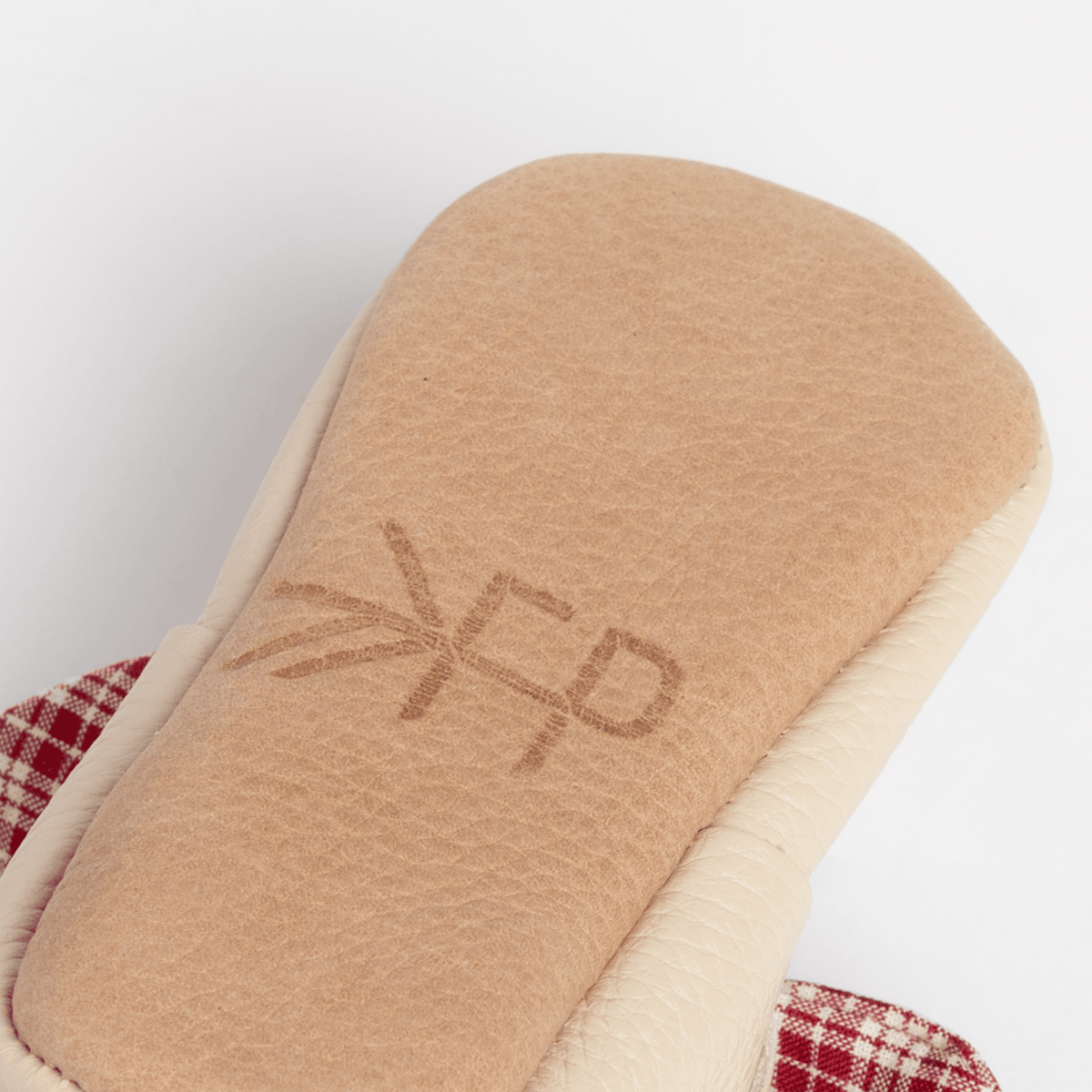 Back of Prairie Girl baby shoe showing faux suede insert with stitched “FP” mark