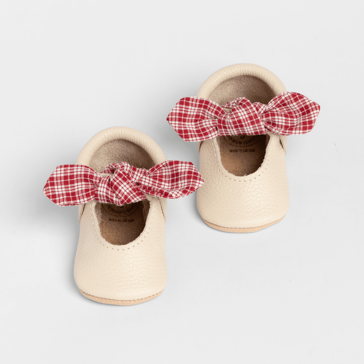 Prairie Girl knotted bow baby shoes in cream leather with red plaid bow