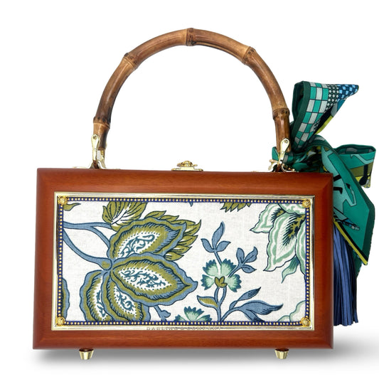Wooden top-handle handbag with blue floral front panel, gold trim, and green scarf detail