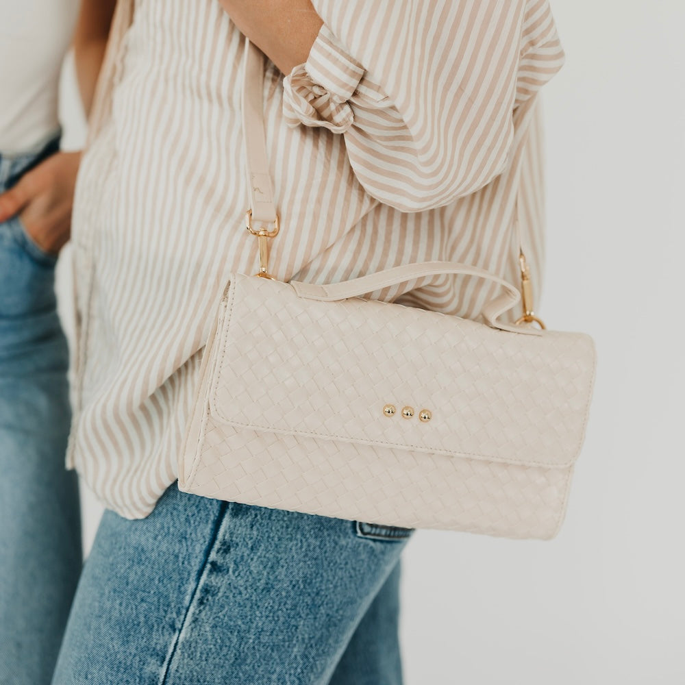 Cream woven foldover clutch crossbody bag with chain strap and snap closure