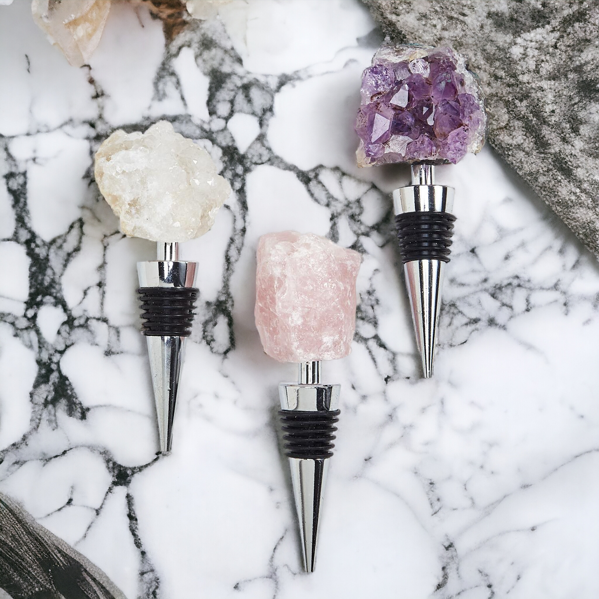 Crystal wine bottle stopper set with purple amethyst, rose quartz, and white stone tops