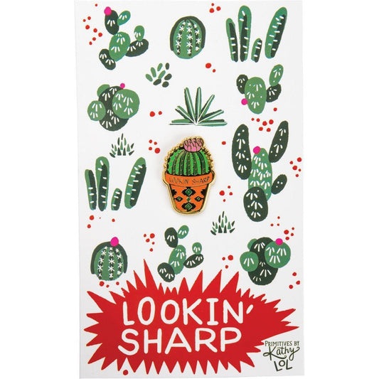 Lookin' Sharp cactus enamel pin on a white gift card with green cactus pattern
