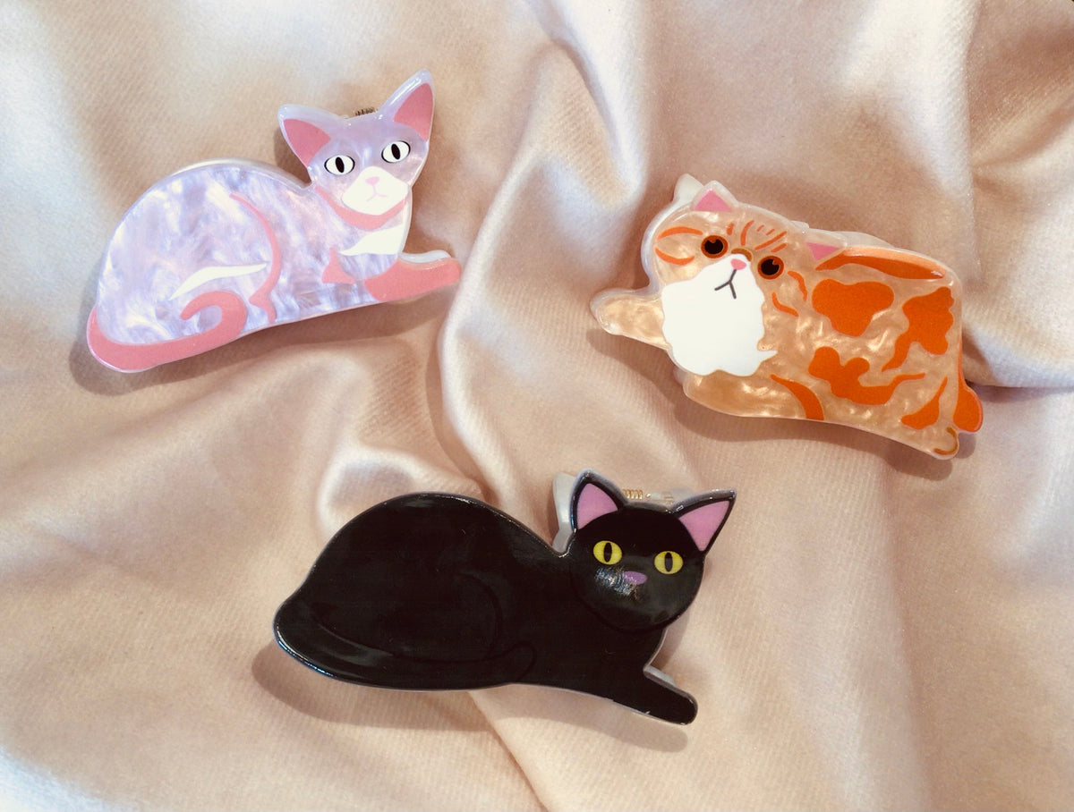 Assorted cat hair claw clips, pink, orange and black with cat face design