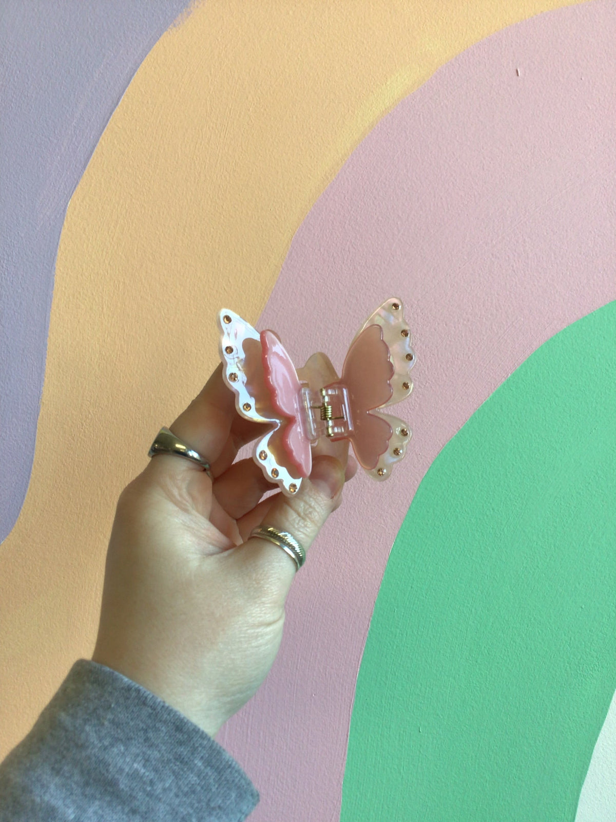 Butterfly hair claw with pink-and-white wings and jeweled edge, silver comb clip