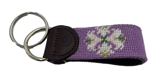 Hand-stitched needlepoint key fob with purple lily flower and leather key-ring strap