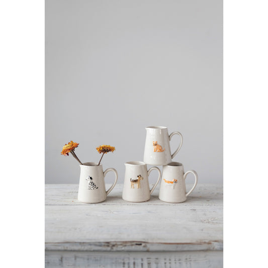 Ceramic animal creamer set of four with painted cat, dalmatian, cat, giraffe-like animal.