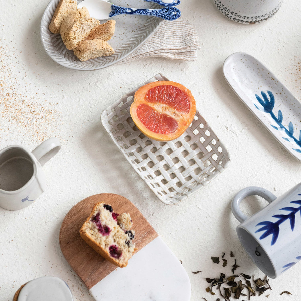 Cream ceramic lattice basket dish with grapefruit and pastry pieces