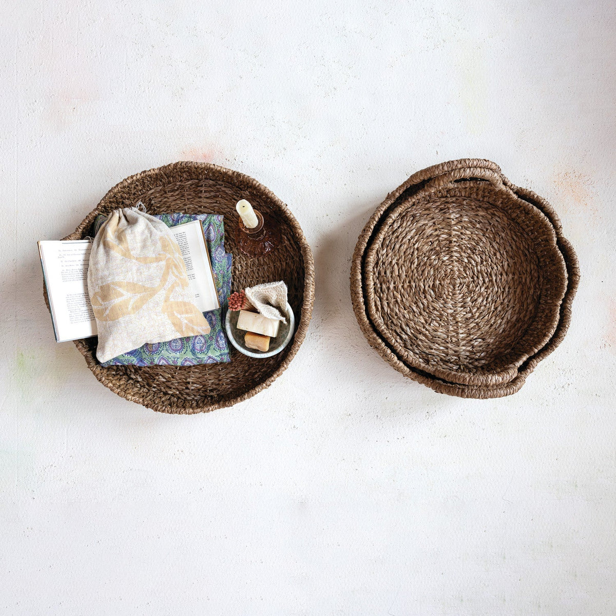 Braided rattan scalloped trays with loop handles, two round woven tray styles