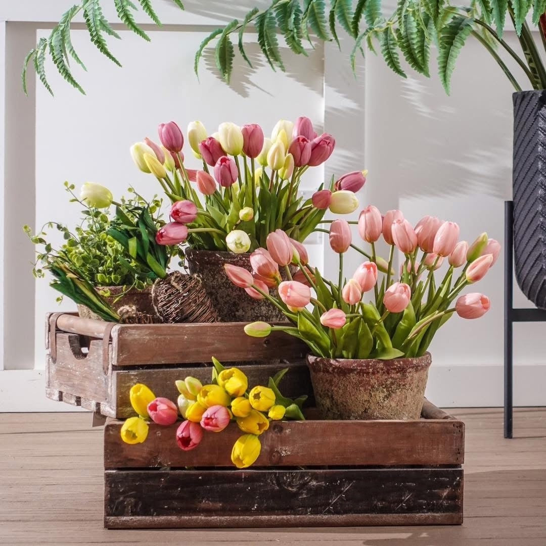 Mixed tulip bouquet with pink tulips and yellow accents, green stems and leaves