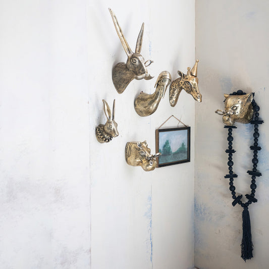 Set of brass-finish duck aviator wall mounts on wall, animal head decor