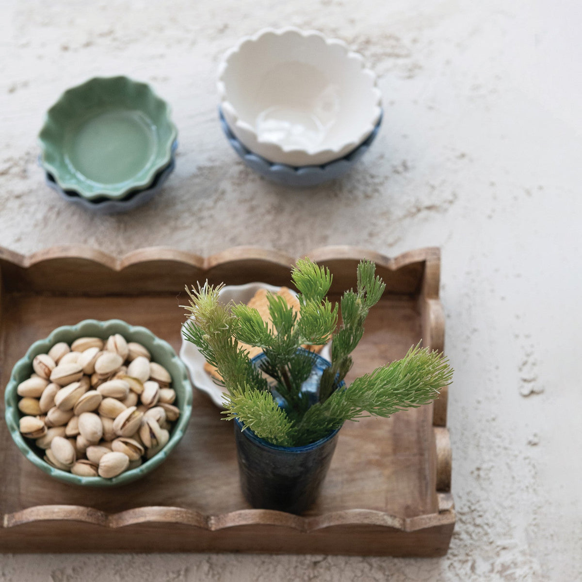 Scalloped-edge mango wood serving tray with raised rim and rectangular shape.