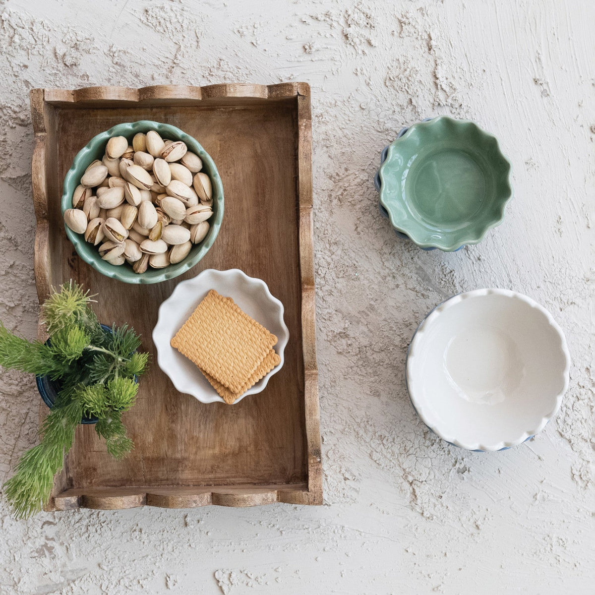 Rectangular mango wood scalloped-edge tray with bowl of beans and small dish items.