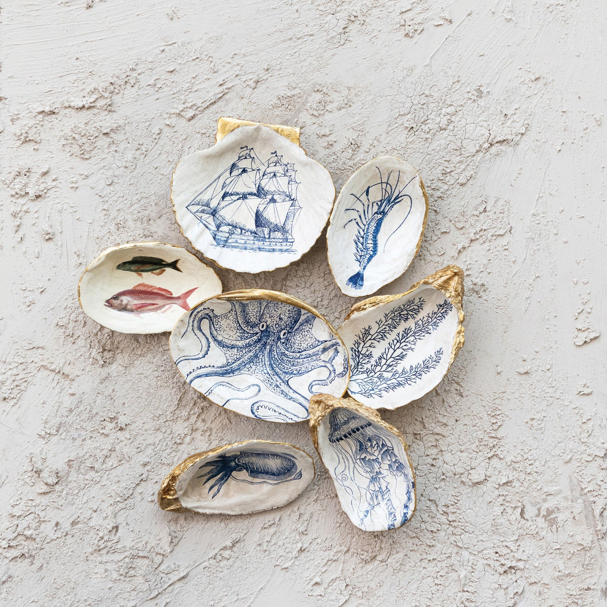 Assorted blue sea-life shell trinket dishes with gold rims and mixed shapes