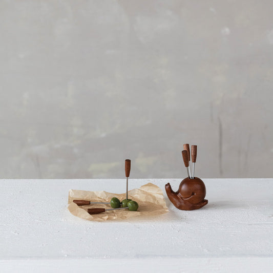 Snail-shaped wooden holder with 6 stainless steel picks on a serving tray