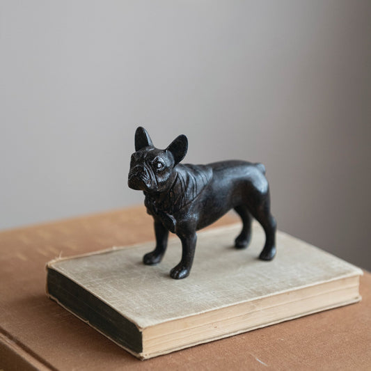 Black French bulldog resin figurine, front-left angle, glossy textured surface.