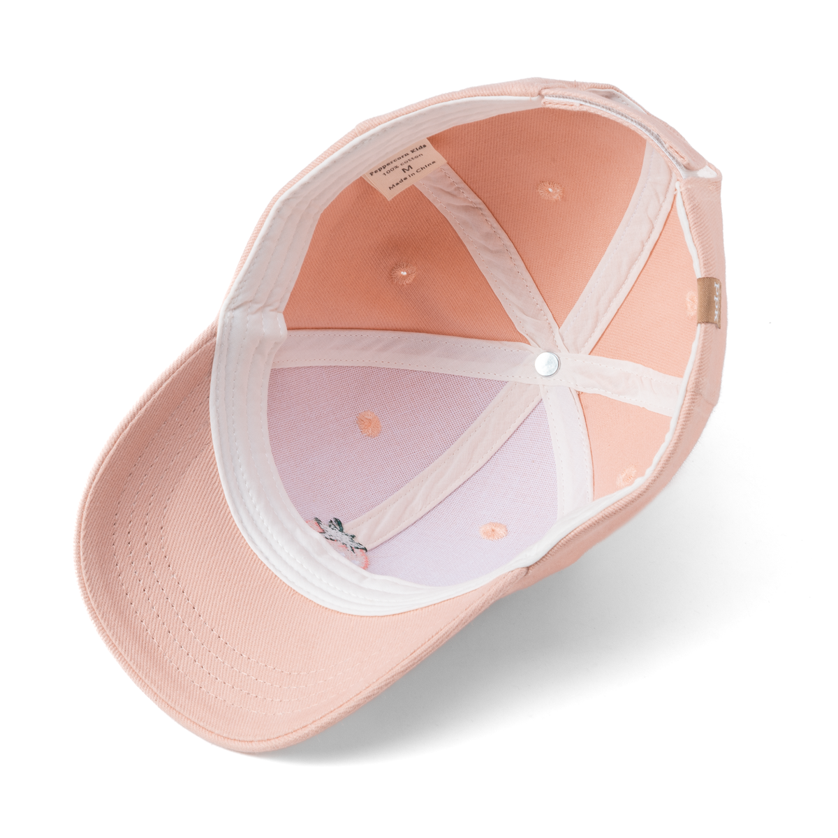 Underside of pink baseball cap showing stitched panels and brim