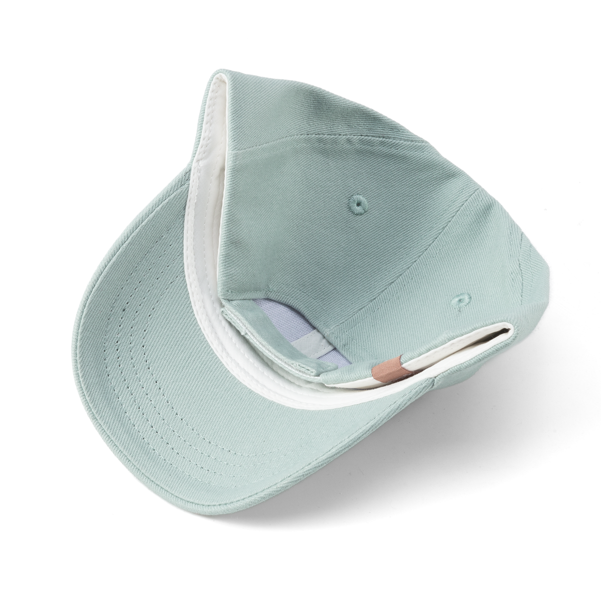 Inside view of pale blue children's baseball cap showing the adjustable strap and brim stitching