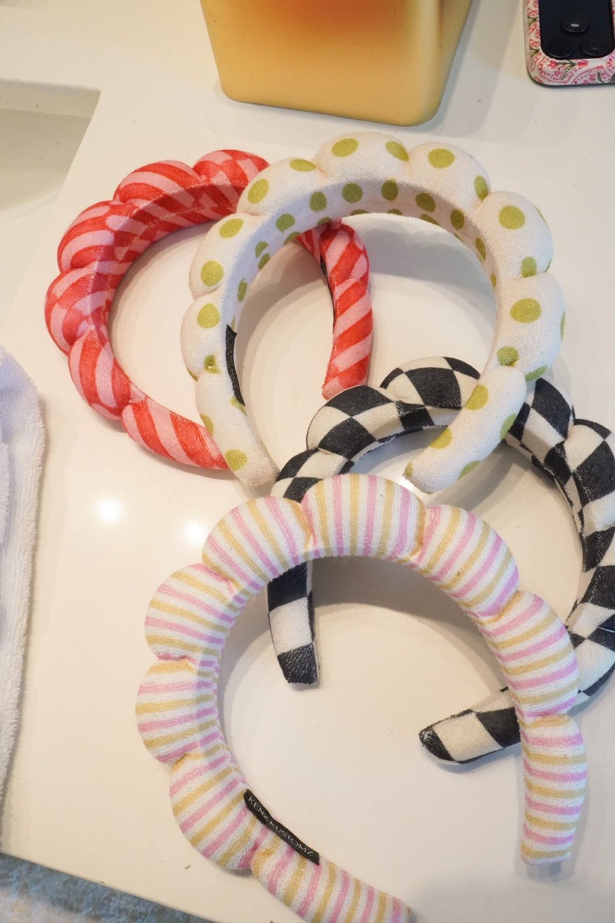 Plush fabric headbands set with red gingham, yellow polka dot, and checkered loops