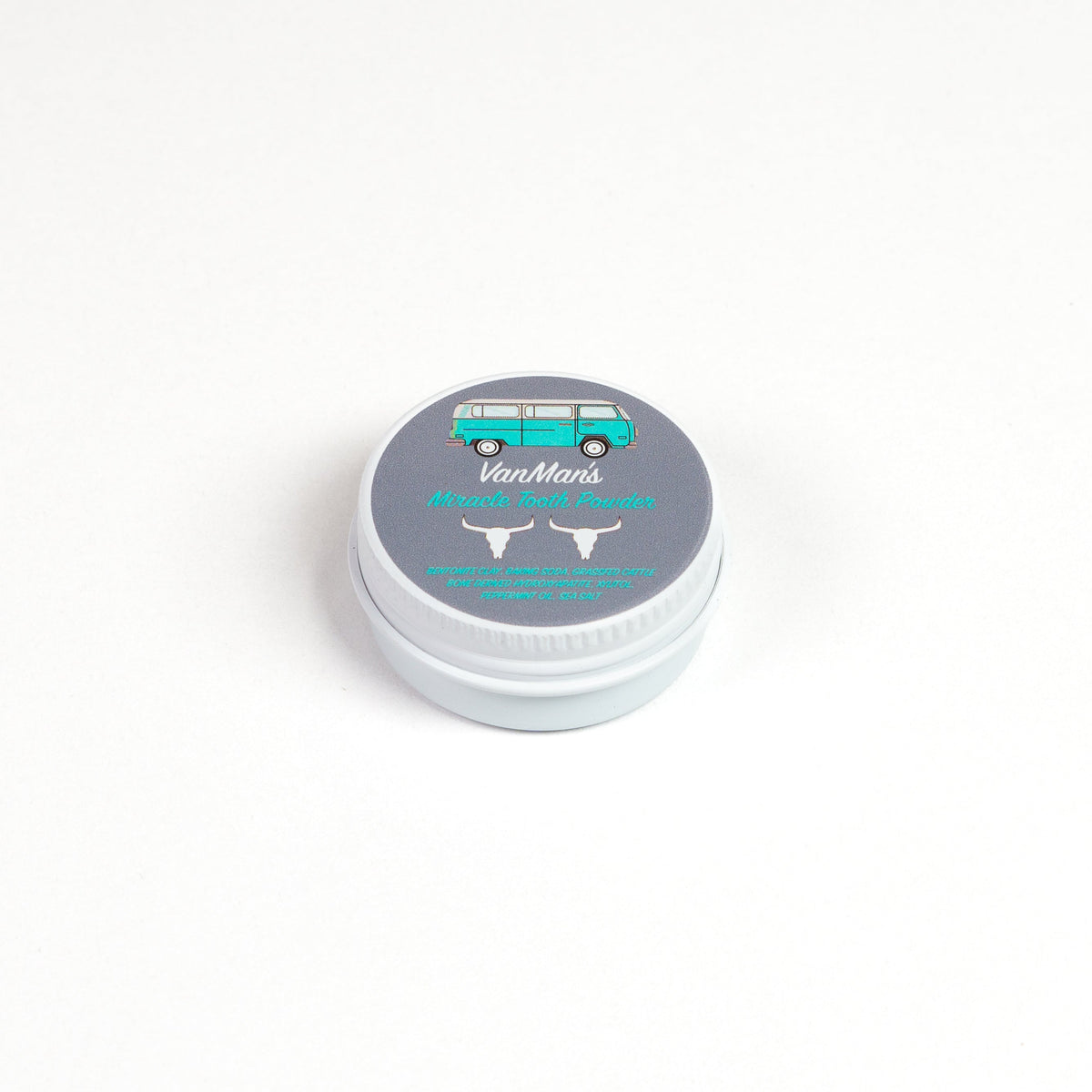 Round tooth powder tin with light gray lid labeled “Cinna-Bone Tooth Powder”
