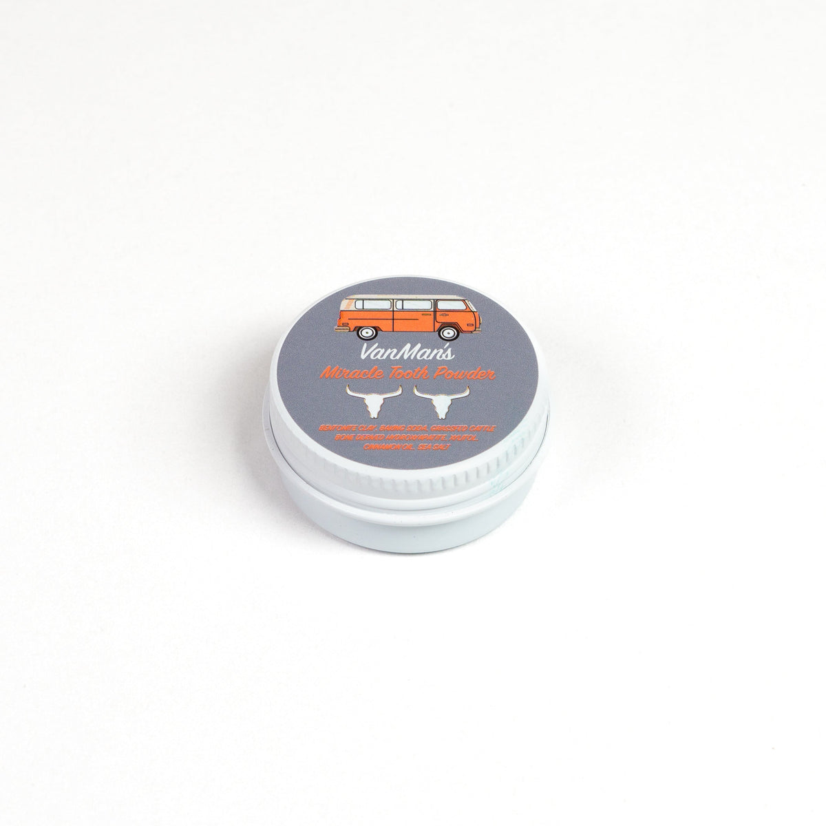 Round tooth powder tin with light gray lid labeled “Cinna-Bone Tooth Powder”