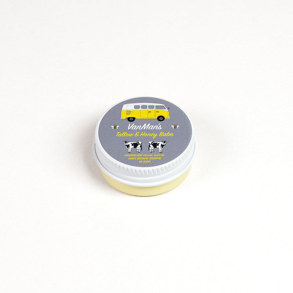 Round balm tin with white lid labeled “Tallow & Honey Balm”
