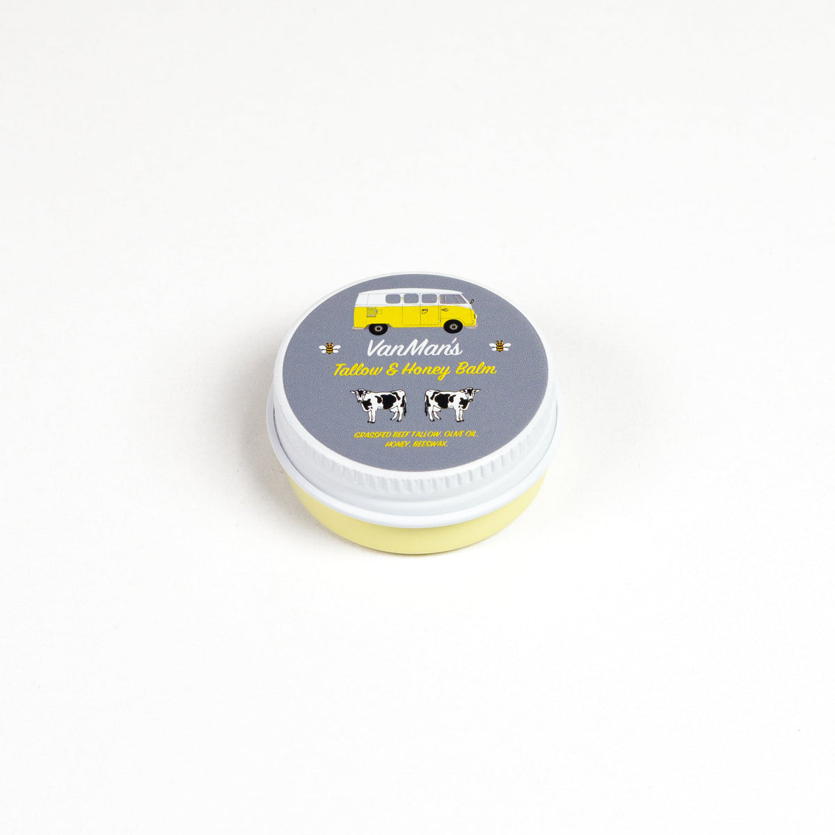 Round balm tin with white lid labeled “Tallow & Honey Balm”