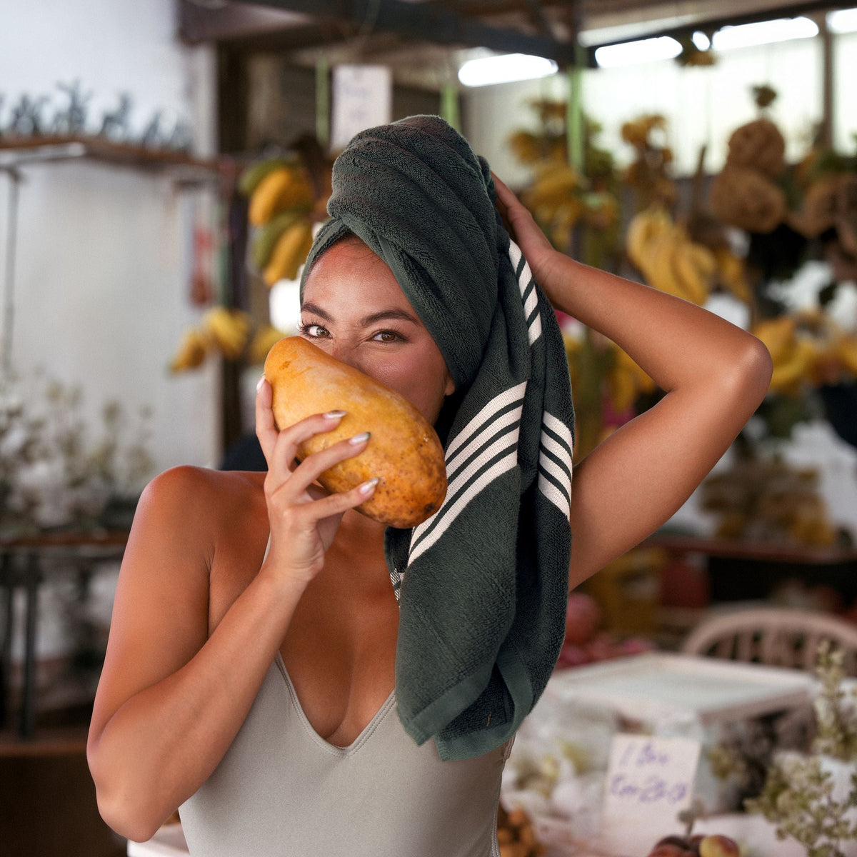 Dark green Australian cotton towel with white stripe wrapped on head and shoulders