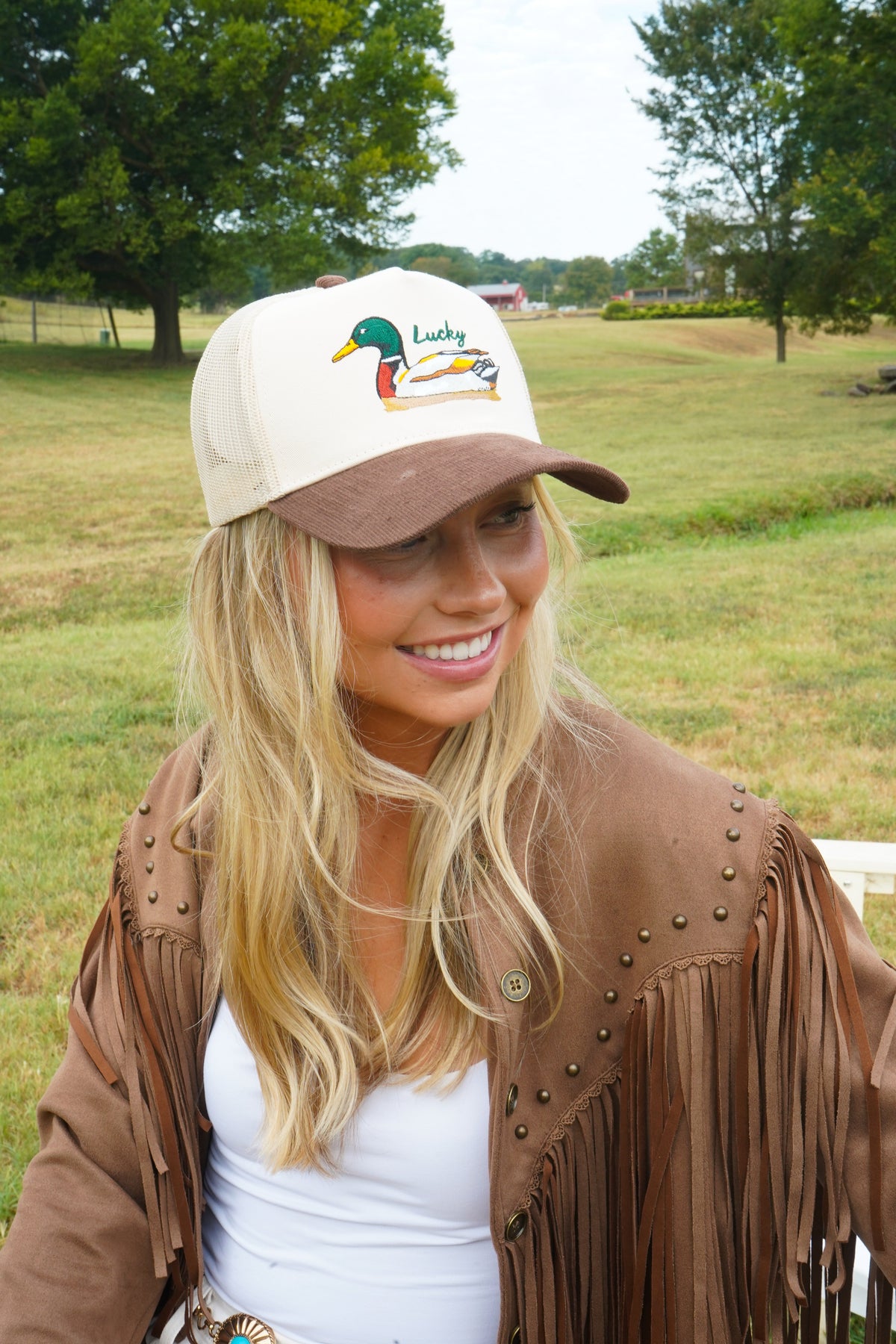Brown corduroy trucker hat with cream front panel and duck “Lucky” logo.